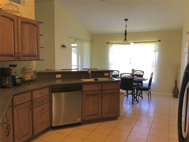 kitchen featuring lofted ceiling, dishwasher, hanging light fixtures, sink, and light tile patterned floors