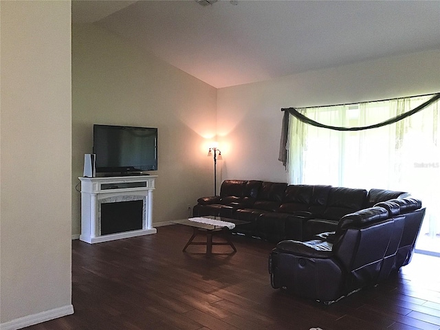 living room featuring lofted ceiling and dark hardwood / wood-style floors