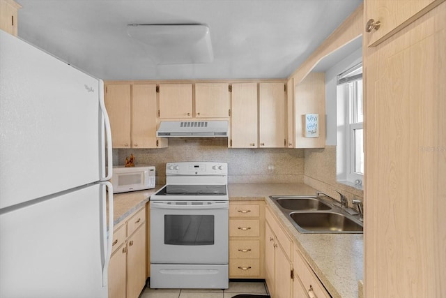 kitchen featuring white appliances, tasteful backsplash, light brown cabinetry, sink, and light tile patterned floors