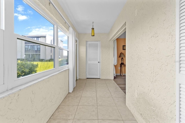 hallway featuring light tile patterned floors