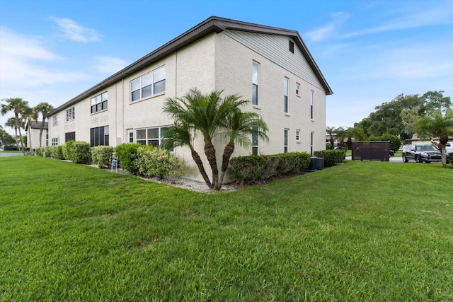 view of property exterior featuring cooling unit and a lawn