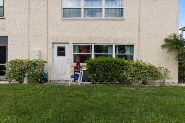 doorway to property with a yard