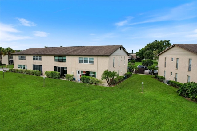 rear view of property with a yard