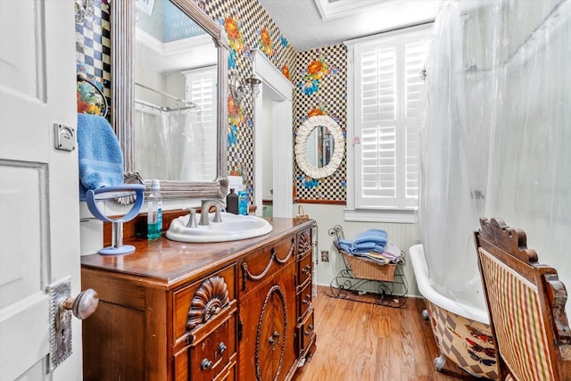 bathroom with vanity, hardwood / wood-style floors, and independent shower and bath