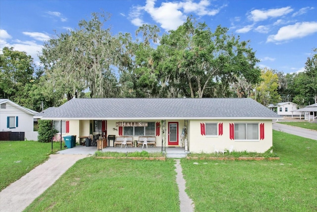 single story home with covered porch and a front lawn