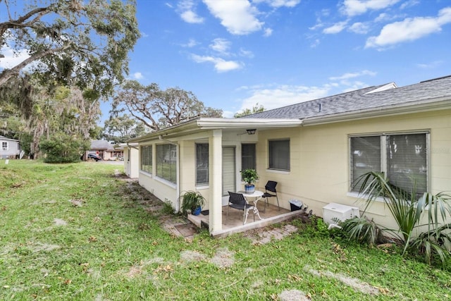 exterior space with a patio and a lawn