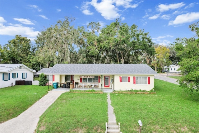 ranch-style home with a front yard and a porch