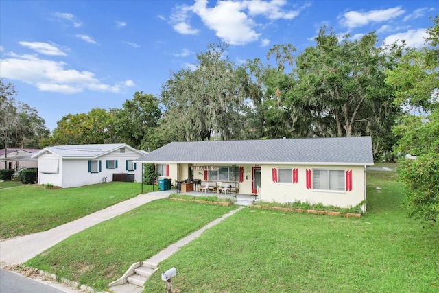 ranch-style house with a porch and a front lawn