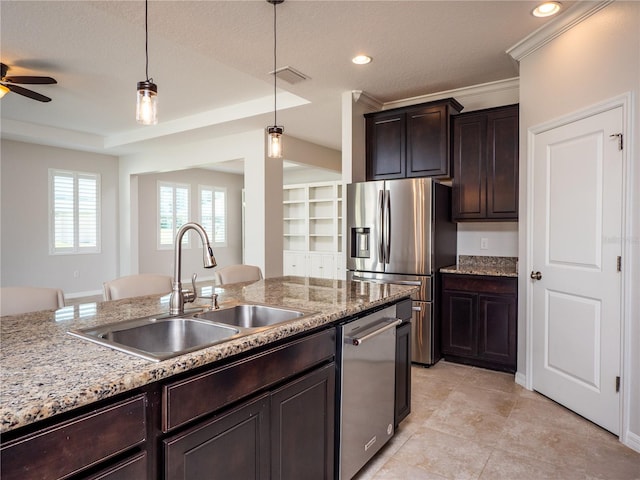 kitchen with stainless steel appliances, a textured ceiling, sink, and hanging light fixtures