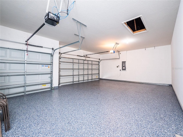 garage featuring a garage door opener and electric panel