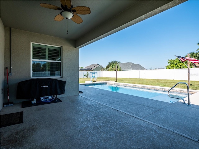 view of pool featuring a patio, ceiling fan, and a yard