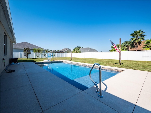 view of swimming pool featuring a yard and a patio