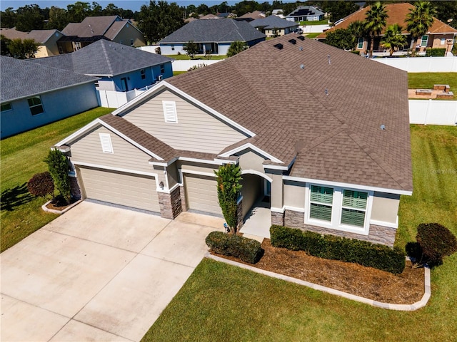 view of front of property with a garage and a front lawn