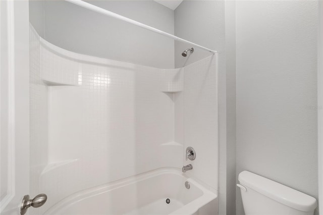 bathroom with bathtub / shower combination and toilet