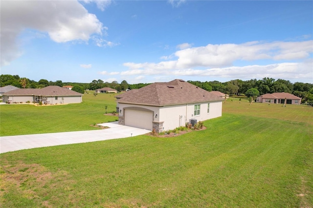 view of side of property with central AC, a garage, and a lawn