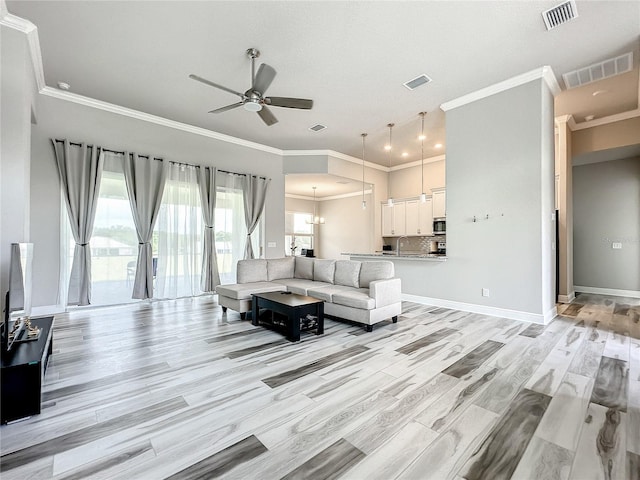 living room featuring light hardwood / wood-style flooring, ornamental molding, sink, and ceiling fan with notable chandelier