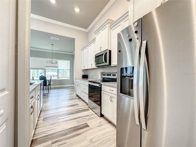 kitchen featuring crown molding, appliances with stainless steel finishes, white cabinetry, light stone counters, and light hardwood / wood-style flooring