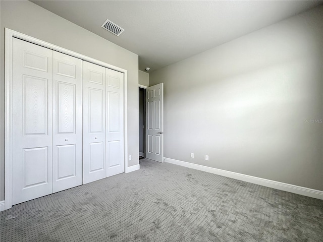 unfurnished bedroom featuring a closet and carpet flooring