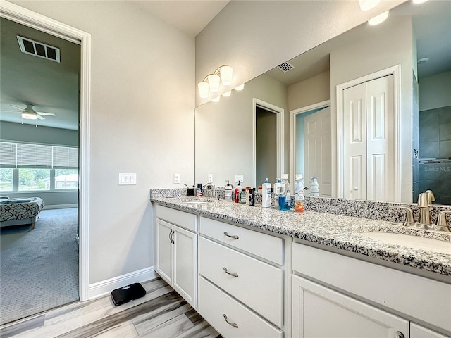 bathroom with vanity, ceiling fan, and wood-type flooring