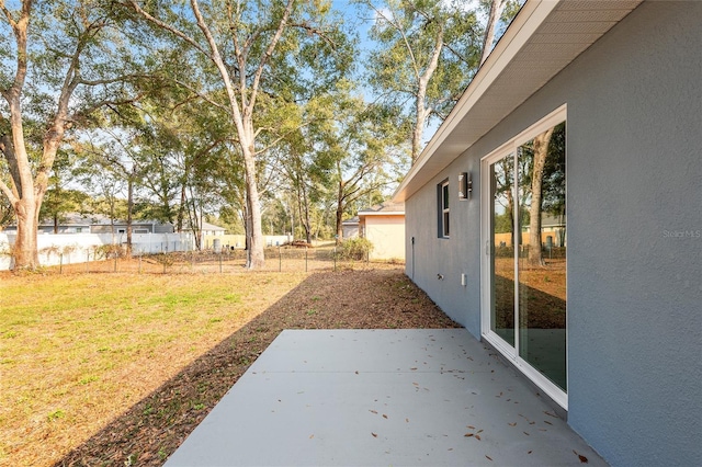 view of yard featuring fence and a patio