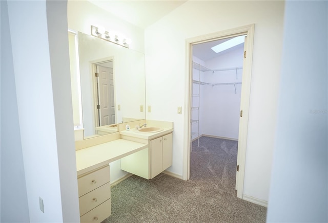 bathroom with lofted ceiling and vanity