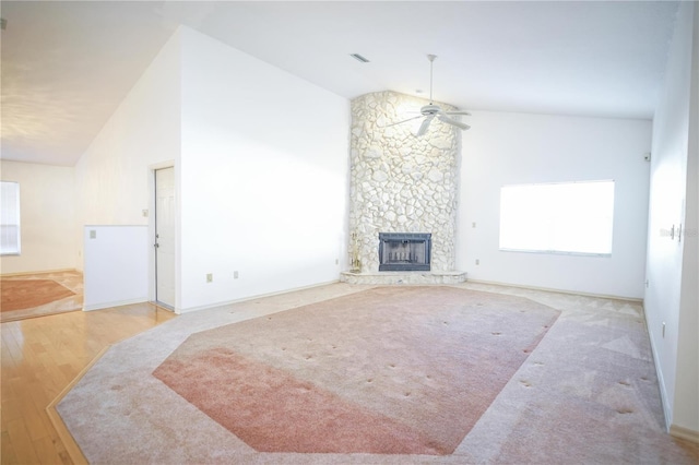 living room with ceiling fan, light wood-type flooring, high vaulted ceiling, and a fireplace