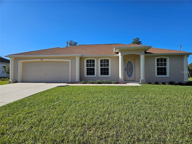 single story home featuring concrete driveway, an attached garage, a front yard, and stucco siding