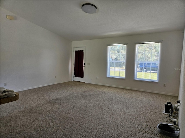 unfurnished room featuring baseboards and carpet