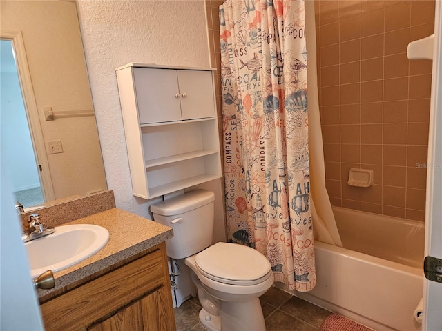 full bathroom with tile patterned floors, vanity, toilet, shower / tub combo with curtain, and a textured wall