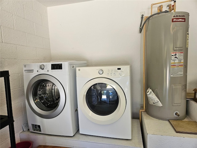 laundry area with electric water heater and washing machine and dryer