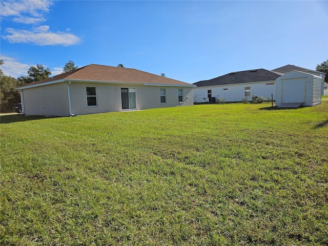 back of property with a storage shed and a yard