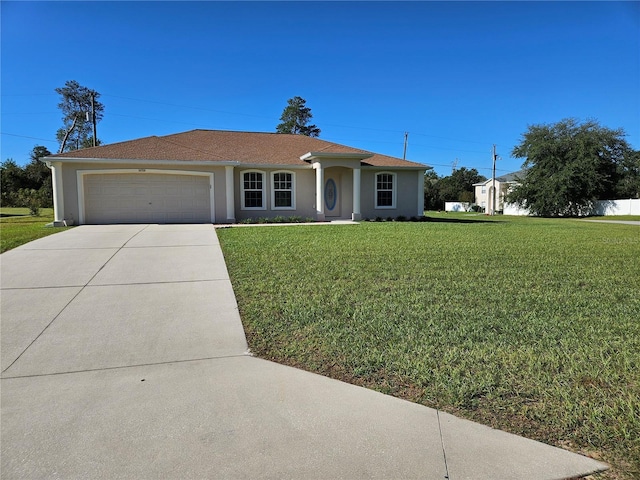 ranch-style home with a garage and a front lawn