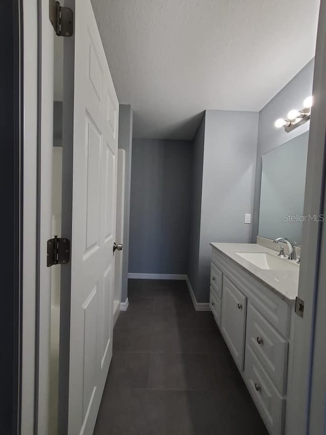 bathroom with vanity and tile patterned flooring