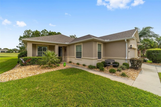 ranch-style home featuring a garage and a front yard