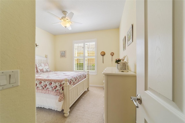 bedroom featuring light carpet and ceiling fan