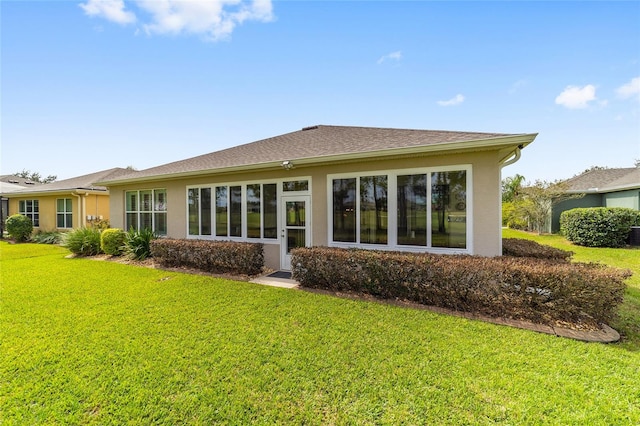 rear view of property featuring a yard