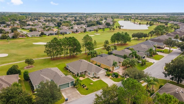 bird's eye view with golf course view, a water view, and a residential view