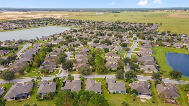 birds eye view of property with a residential view and a water view