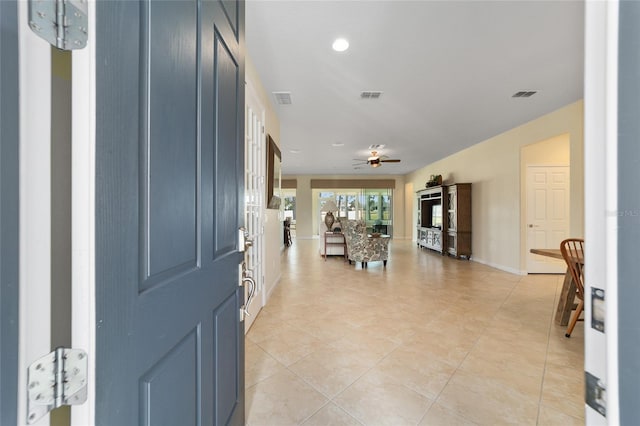 tiled entrance foyer with ceiling fan