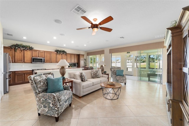 tiled living room featuring ceiling fan