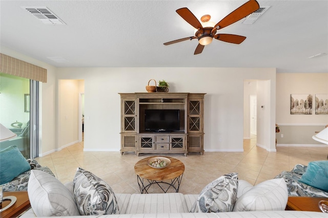 tiled living room featuring ceiling fan