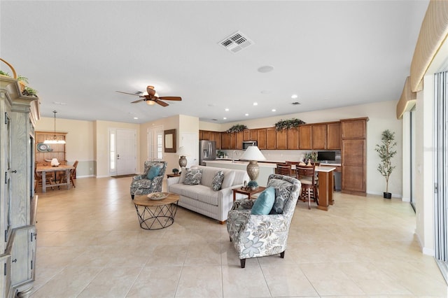 tiled living room with ceiling fan