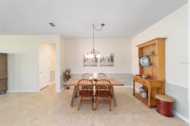 tiled dining area with a notable chandelier