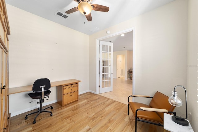 office space featuring french doors, light hardwood / wood-style flooring, and ceiling fan