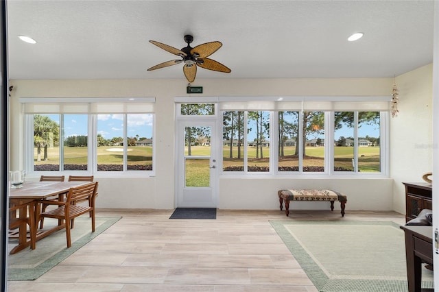 sunroom featuring a wealth of natural light and ceiling fan