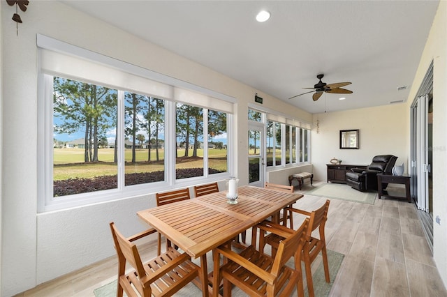 sunroom / solarium with plenty of natural light and ceiling fan