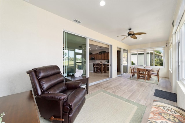 sunroom featuring ceiling fan