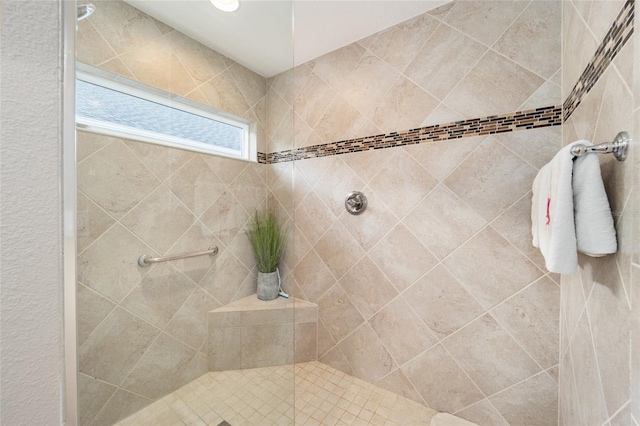 bathroom with a tile shower