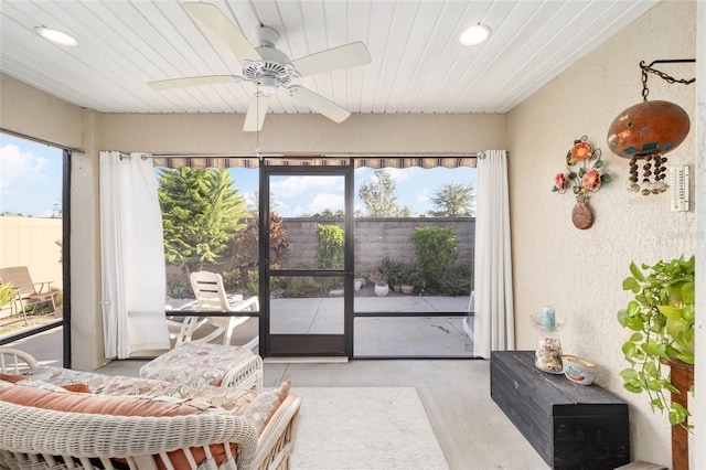 sunroom / solarium featuring wooden ceiling and ceiling fan