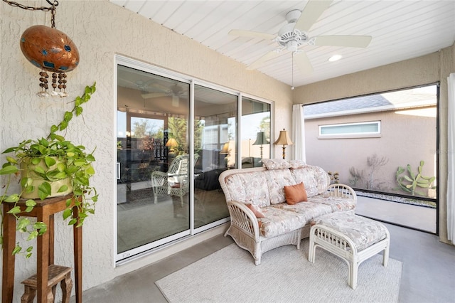 sunroom featuring plenty of natural light, ceiling fan, a skylight, and wood ceiling